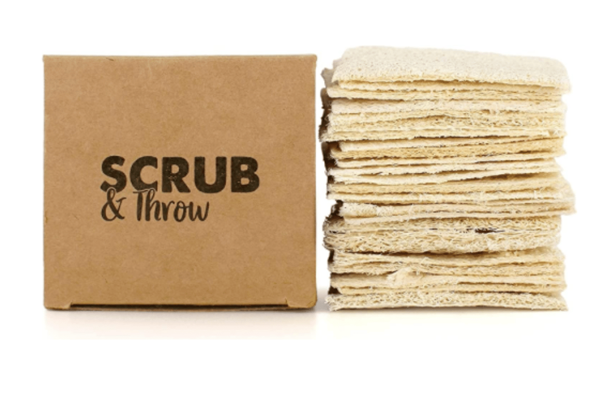 Scrub & Throw natural loofah scrub sponges, a stack of flat dried loofah pads beside a plain cardboard box
