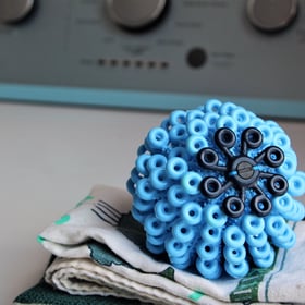 Cora Ball, a spiky blue spherical laundry ball that catches microfibers in the wash