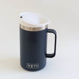 Just a Lid white ceramic travel mug lid shown on a stainless tumbler on a neutral background