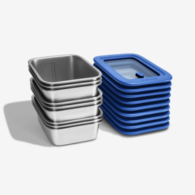 Misenware set - a stack of stainless steel food storage containers beside a stack of matching silicone-rimmed tempered glass lids