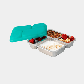 PlanetBox Voyager stainless tray with four compartments holding berries, granola, yogurt and fruit, with its one-piece teal silicone lid propped alongside