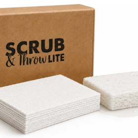 Scrub & Throw Lite natural cellulose sponges, a stack of flat compressed white pads and one expanded wet sponge beside a cardboard box
