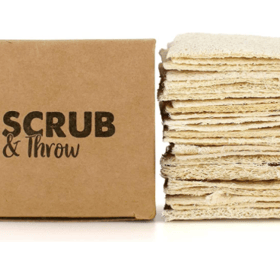 Scrub & Throw natural loofah scrub sponges, a stack of flat dried loofah pads beside a plain cardboard box