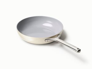 Caraway ceramic nonstick fry pan in Cream with stainless handle, angled view