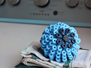 Cora Ball, a spiky blue spherical laundry ball that catches microfibers in the wash