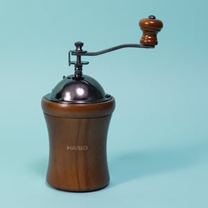 Hario Coffee Mill Dome hand grinder, wooden body with a steel domed hopper and crank handle